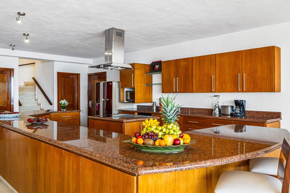 Fully equipped kitchen with granite countertops, modern appliances, and a spacious island for cooking and entertaining.