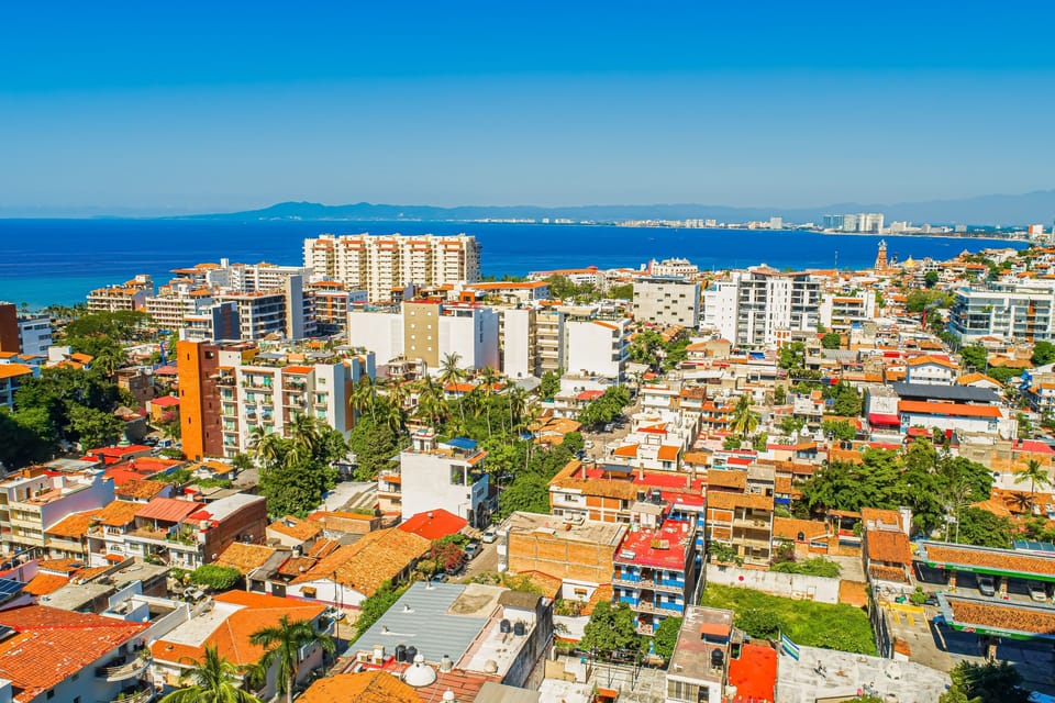 Beautiful high-perspective shot framing the cityscape blending seamlessly with the expansive ocean background.