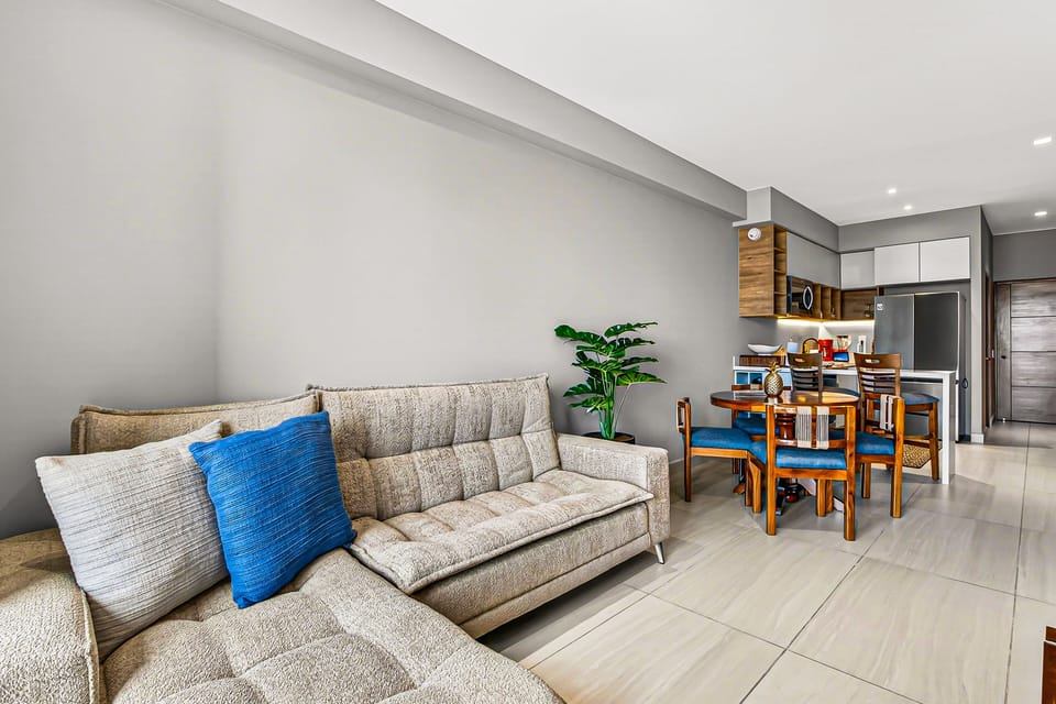Spacious living and dining area with modern furnishings perfect for relaxing, entertaining, or enjoying meals together.