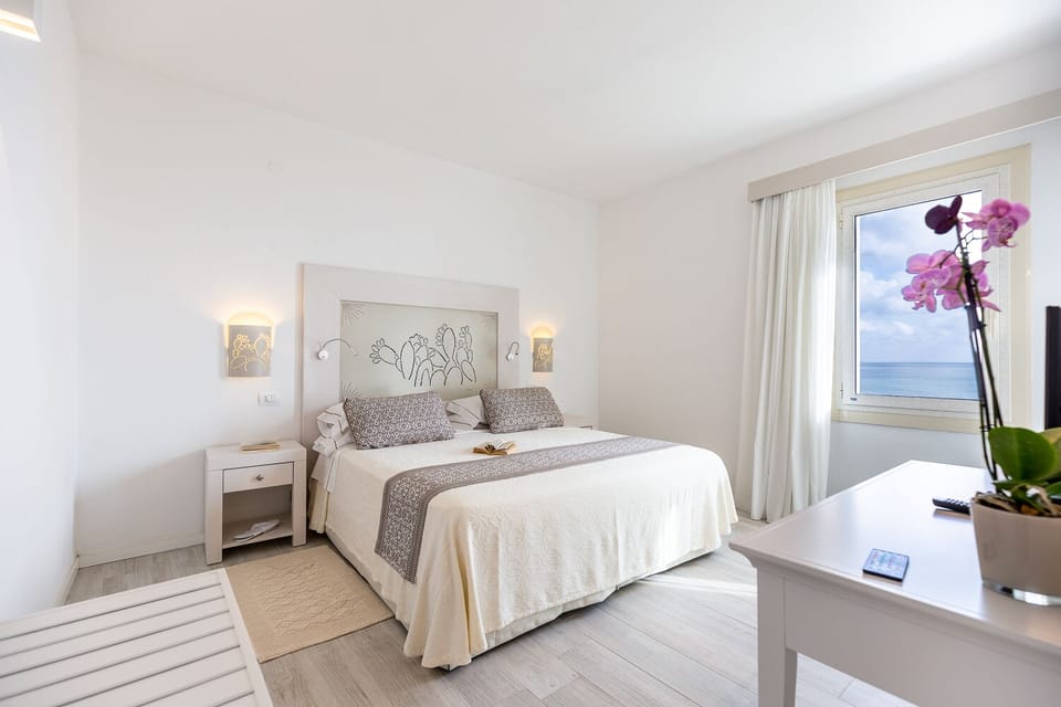 Suite, Sea View | Minibar, in-room safe, desk, laptop workspace