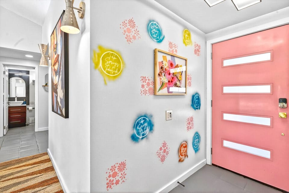 Step through the pink front door into your stylish Palm Springs mid-century getaway.