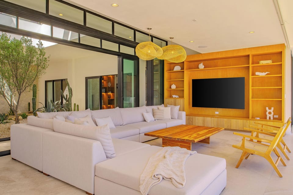 Settle into this stunning living room where modern elegance meets comfort. The plush sectional and warm wood entertainment center create your perfect gathering space.