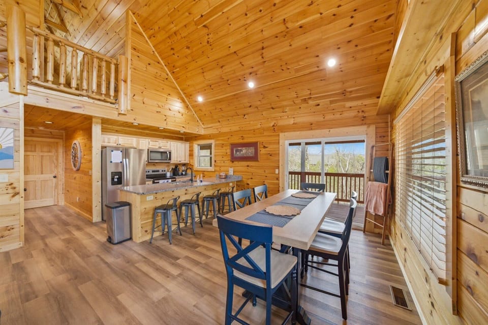 Gather around this spacious kitchen and dining area where warm wood surrounds you, natural light streams in, and meals become memories.