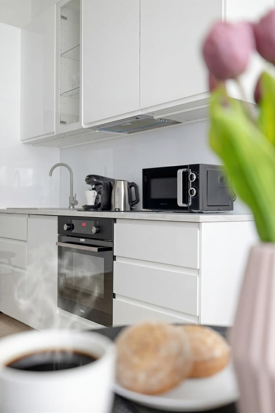 A lifestyle shot focuses on the kitchen elements behind a blurry table in the foreground.