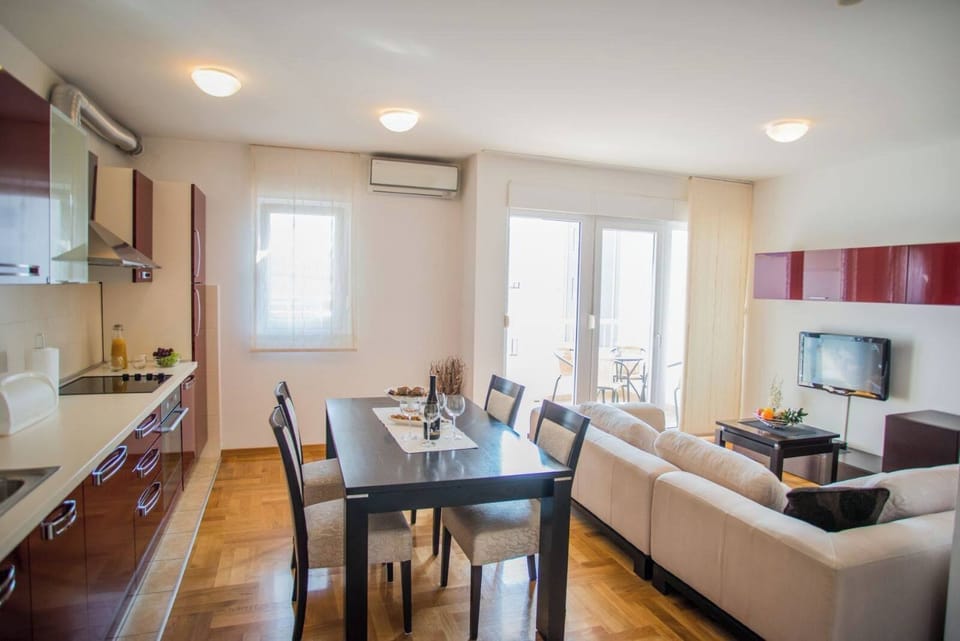 Apartment, Balcony, Sea View | Living area | 100-cm TV with satellite channels