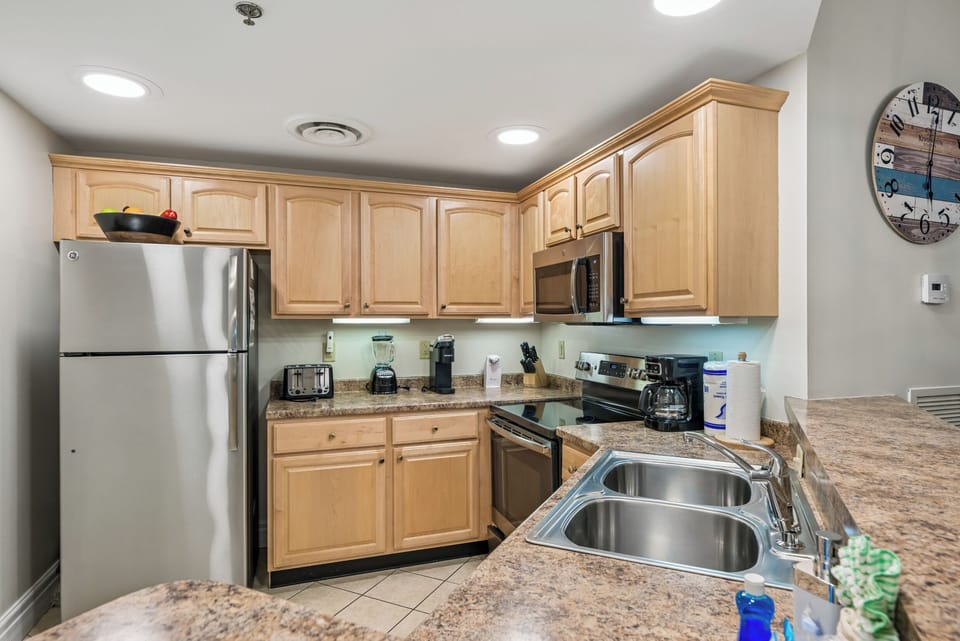 Cook your favorite meals in this fully equipped kitchen featuring granite counters, stainless appliances, and everything you need for home comfort.