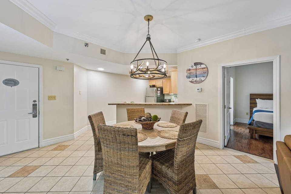 Gather around your spacious dining table beneath coastal charm, where woven chairs invite memorable meals with family and friends.