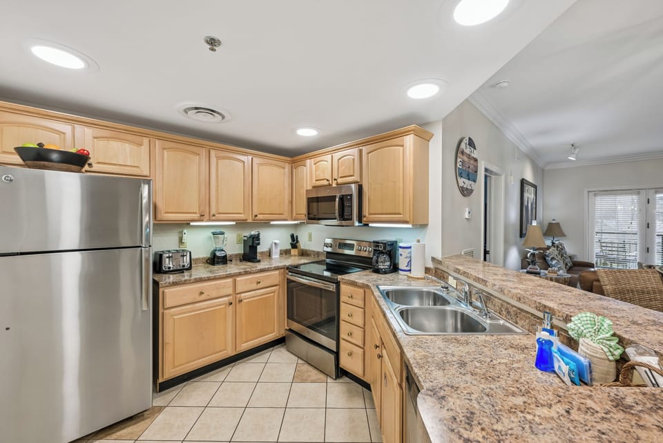 Your fully equipped kitchen features granite countertops, stainless steel appliances, and ample cabinet space for preparing memorable meals during your stay.