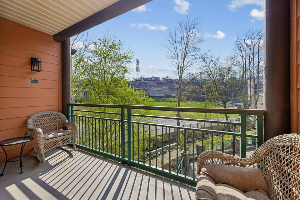 Relax in cozy wicker chairs on your private balcony, where morning coffee tastes better with peaceful views stretching across the valley.