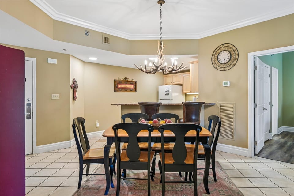 You'll love gathering around this elegant dining table, where the rustic chandelier creates perfect ambiance for memorable meals with loved ones.