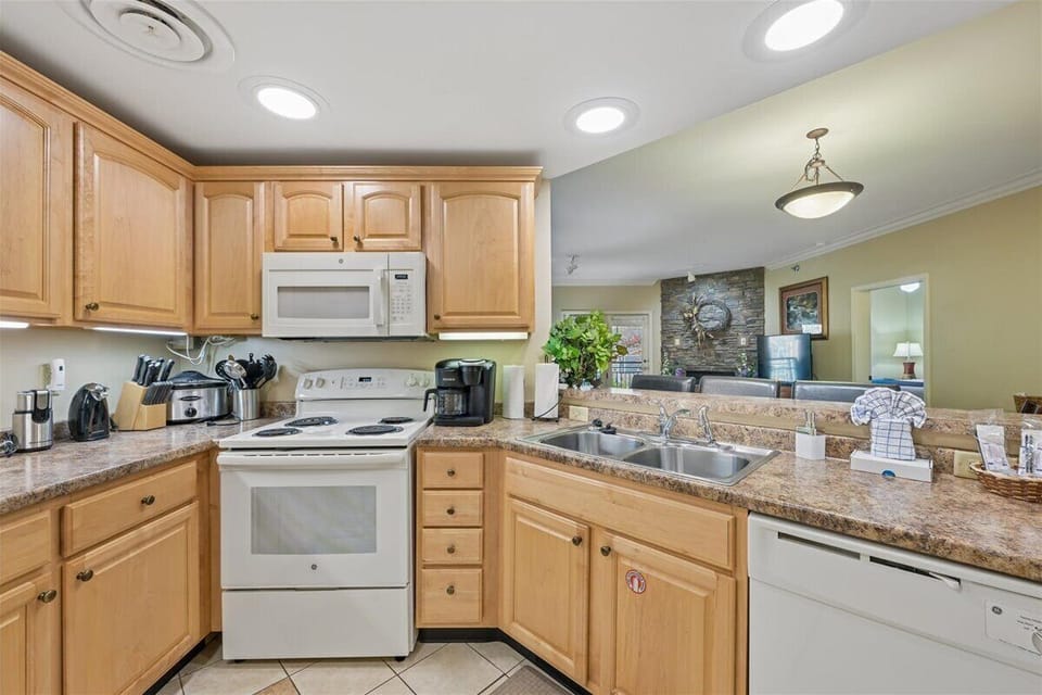 Your fully equipped kitchen features granite counters, warm wood cabinets, and everything needed for home-cooked meals during your stay.