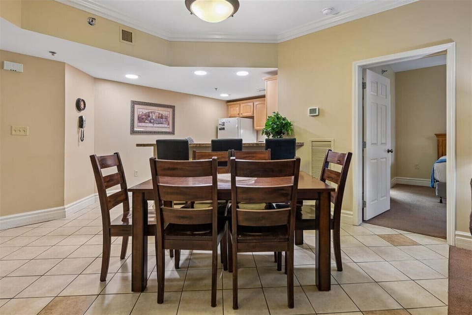 Your spacious dining room features a beautiful wooden table for eight, perfect for family meals and memorable conversations.