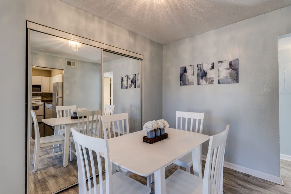 Gather around the bright dining table set for memories, accompanied by chic artwork.