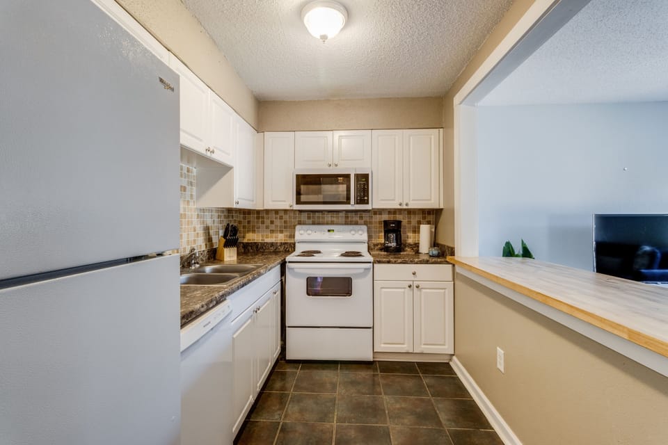 Prepare meals in a well-equipped kitchen with modern appliances and stylish accents.