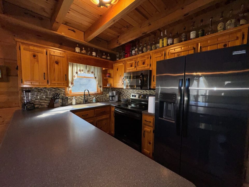 Kitchen: Whip up culinary delights in this charming, fully-equipped kitchen with stunning wood accents!