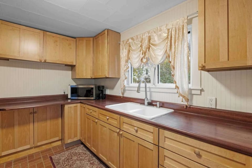 Bright and spacious kitchen featuring ample counter space, cookware, and dishware for your stay.