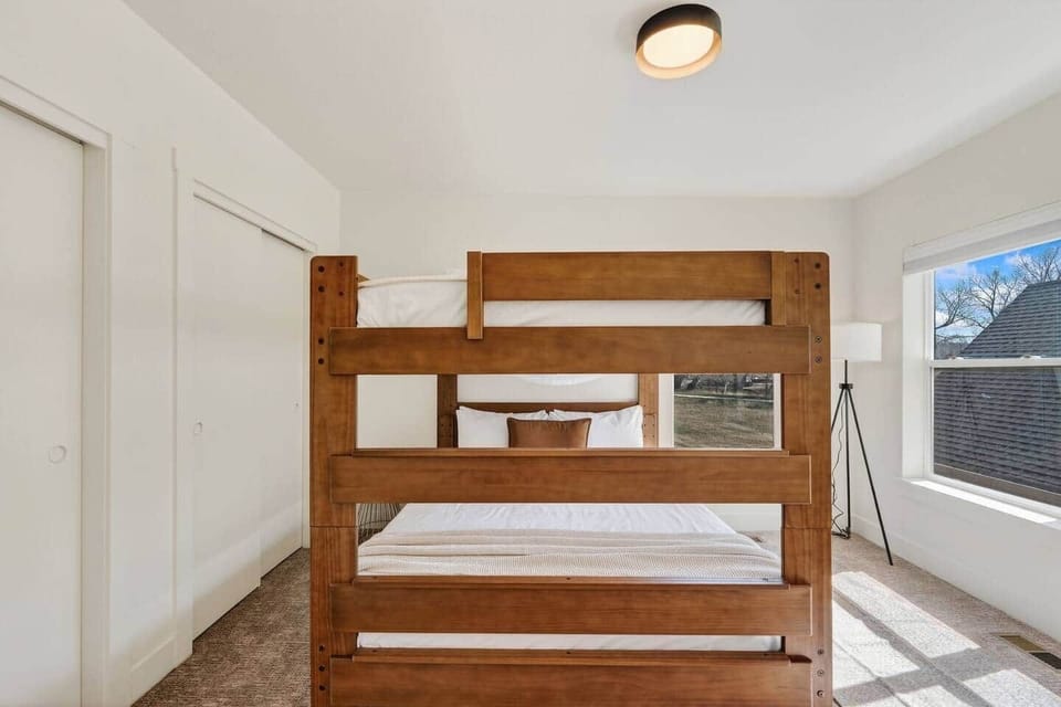 Second bedroom with custom queen-over-queen bunk beds, offering a comfortable and flexible sleeping setup—perfect for families or groups.