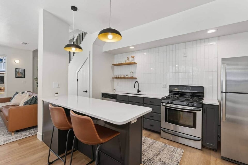 Modern kitchen with clean finishes, stainless steel appliances, and a spacious island with bar seating—perfect for cooking, gathering, and sharing meals together.