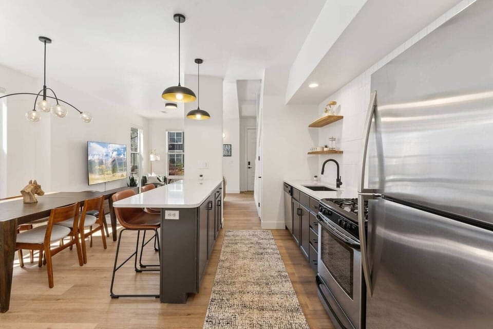 Spacious, open kitchen with a large island and bar seating, seamlessly connecting to the dining and living areas—perfect for cooking, gathering, and staying connected.
