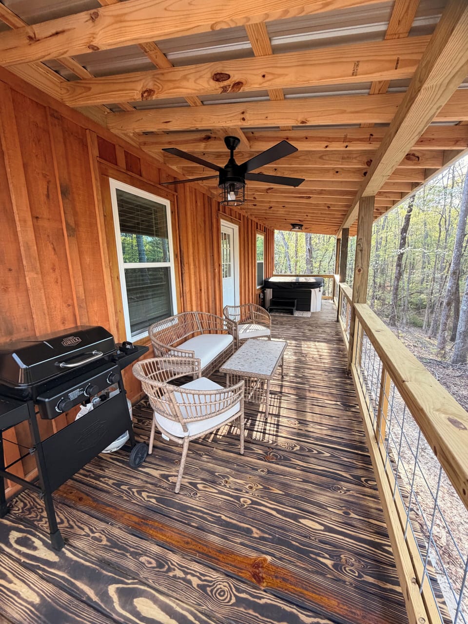 Covered porch with hot tub, grill & seating with beautiful rolling hill views