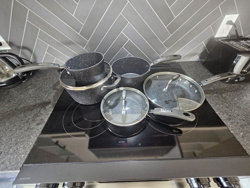 Chef-ready essentials. High-end pots and pans are neatly organized and ready for use in our gourmet kitchen