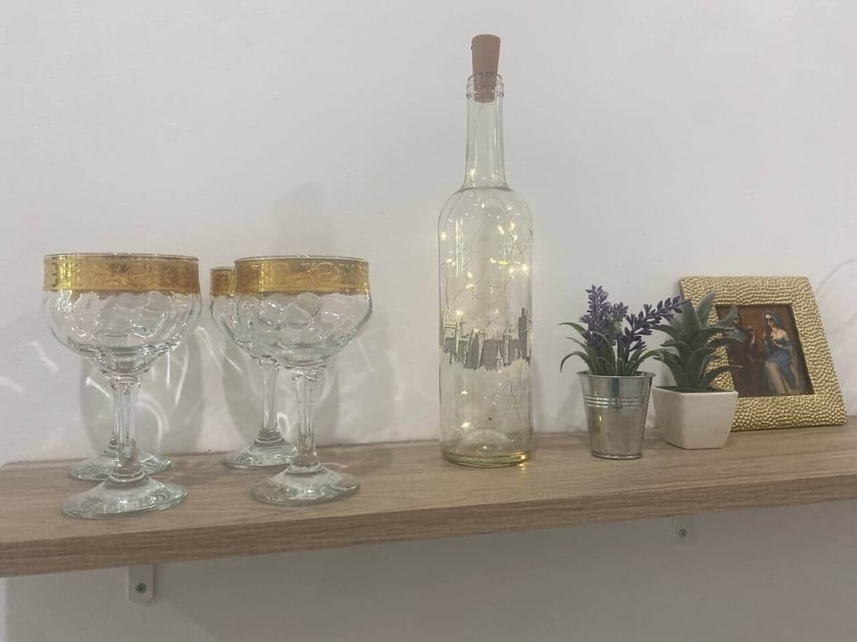 Well-stocked kitchen with essentials like glassware and a stovetop coffee maker for guest convenienc