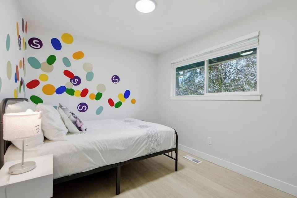 Third bedroom with full bed and playful wall art