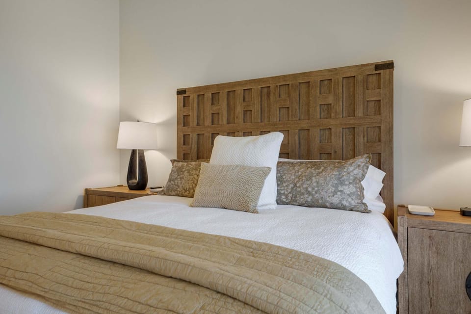 Bedroom 1 with king bed and plush linens