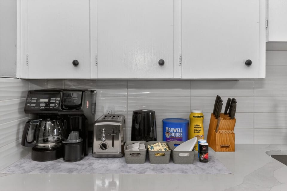 Kitchen equipped with coffee maker and essentials