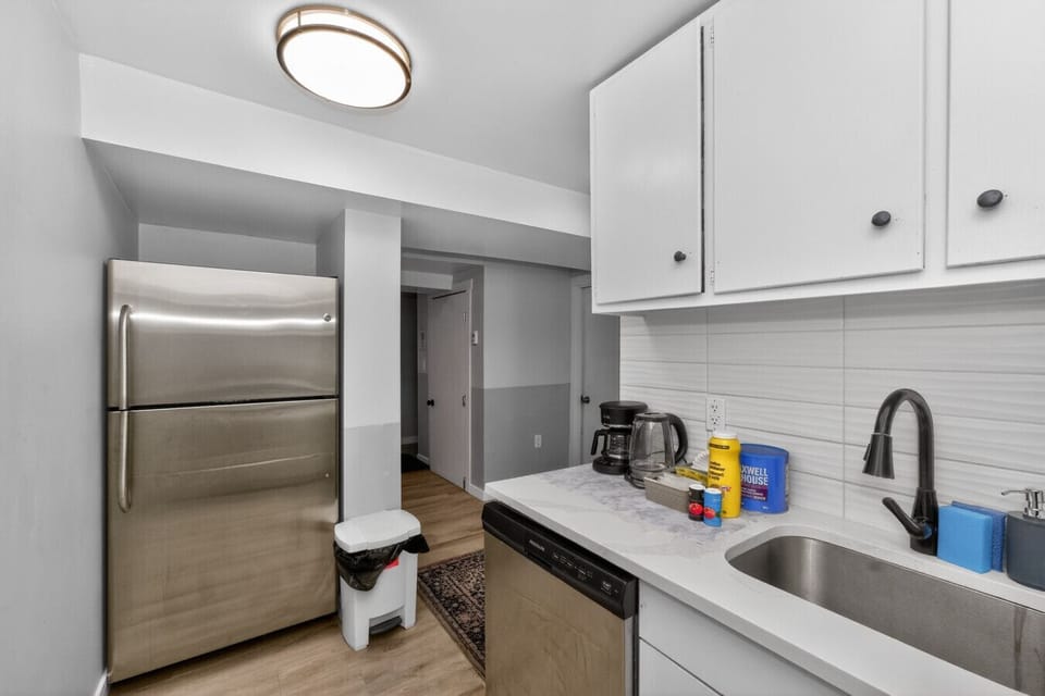 Kitchen area with fridge and cooking essentials