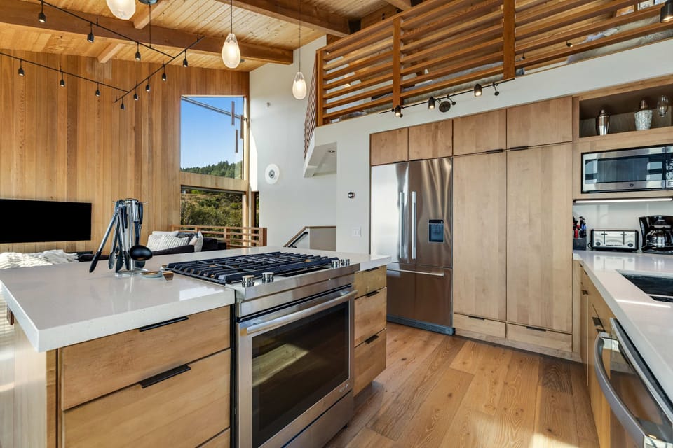 Cook up culinary delights in this modern kitchen, designed with you in mind, featuring ample space and stunning views to inspire your inner chef.
