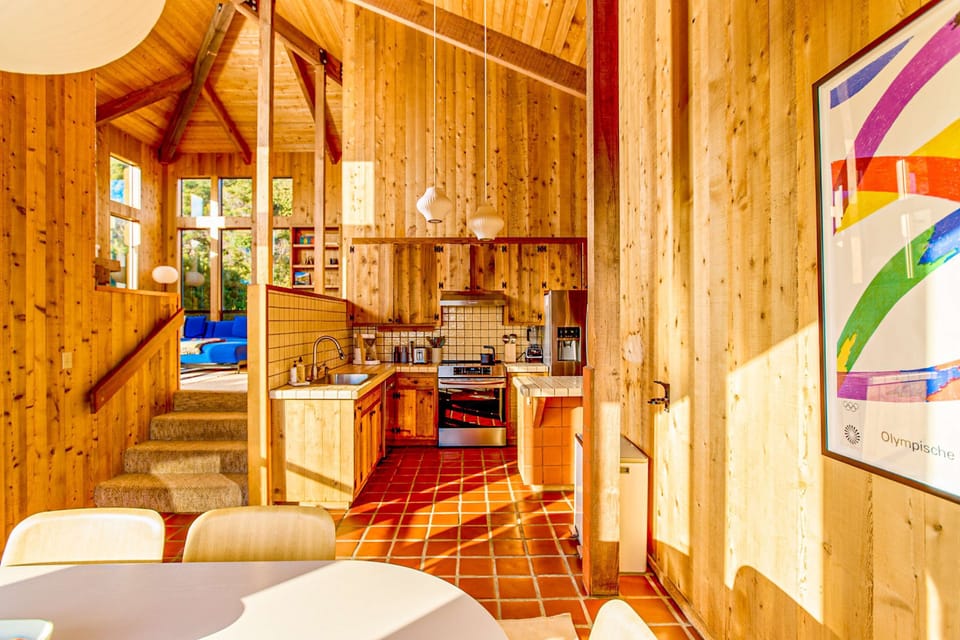 Cook up coastal delights in this charming kitchen, where modern appliances meet rustic wooden accents for an inviting culinary experience.