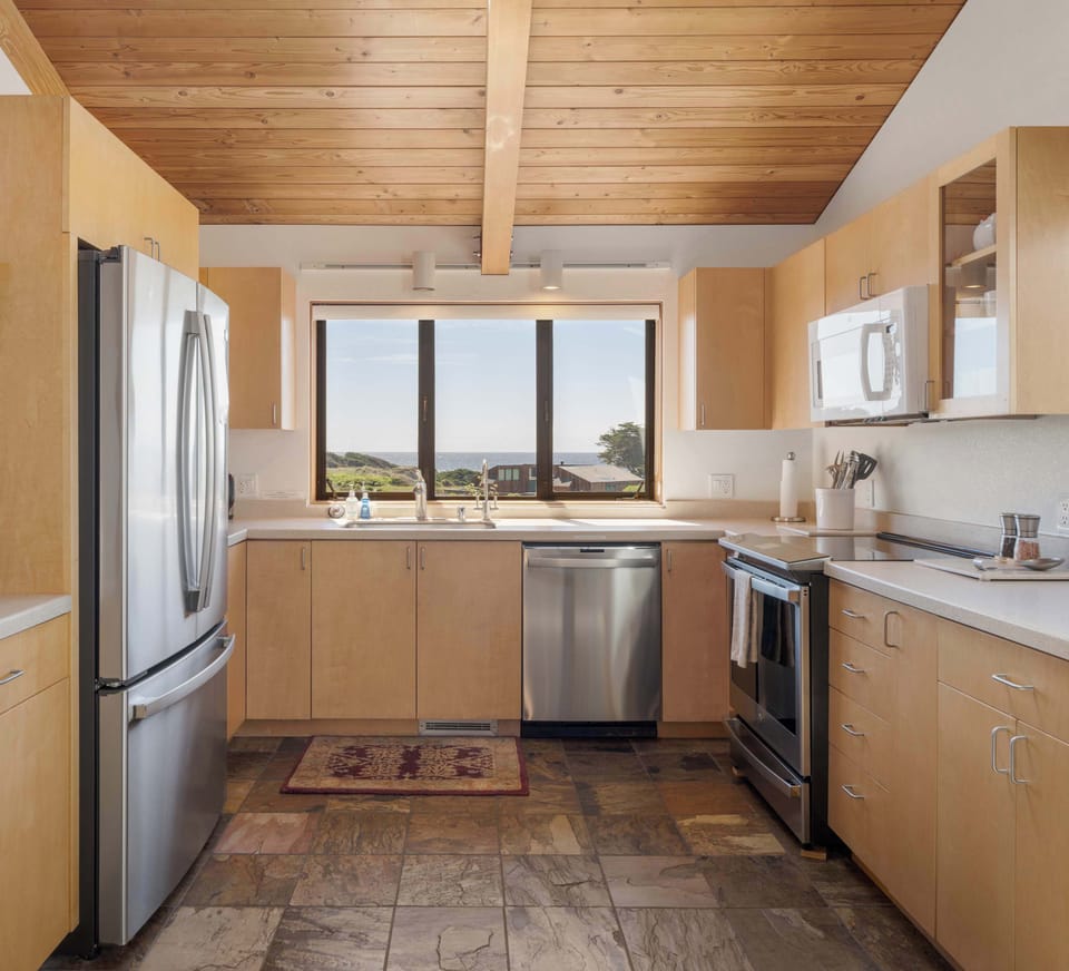 Stainless steel appliances, ample counter space, and an ocean view above the sink make this kitchen a pleasure to cook in.
