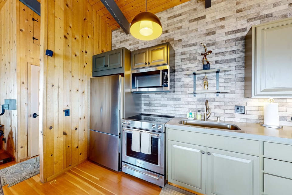 Craft culinary delights in the well-equipped kitchen, where the charm of rustic wood meets modern appliances, making meal prep a joy.