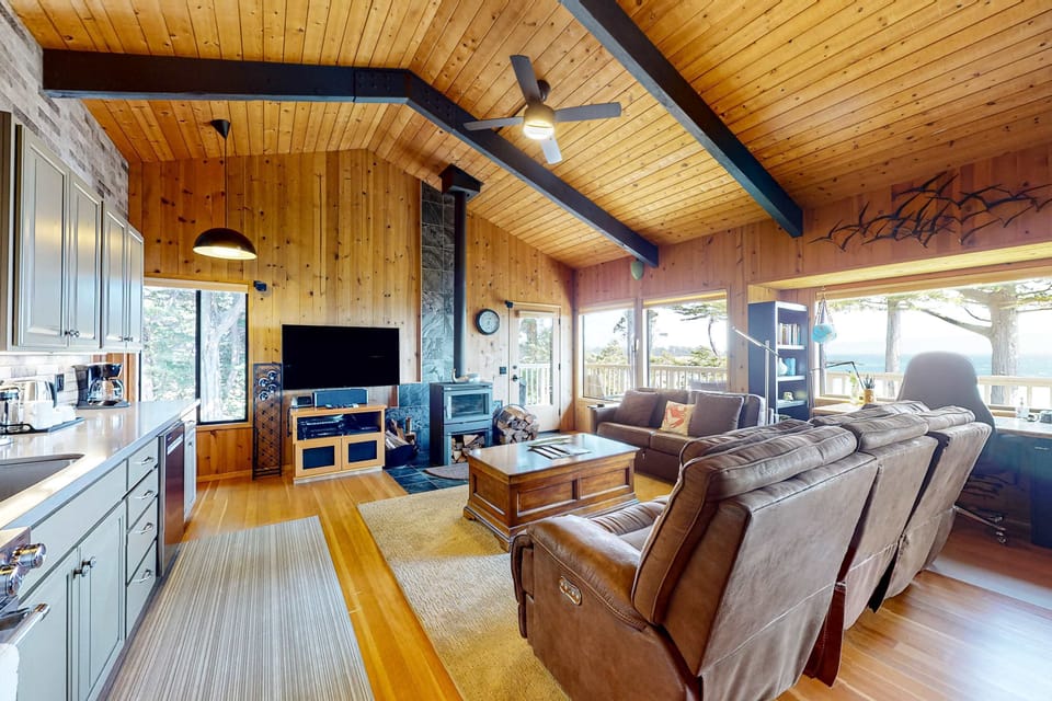 Relax in the inviting living room, where you can enjoy movie nights or simply bask in the warmth of the fireplace.