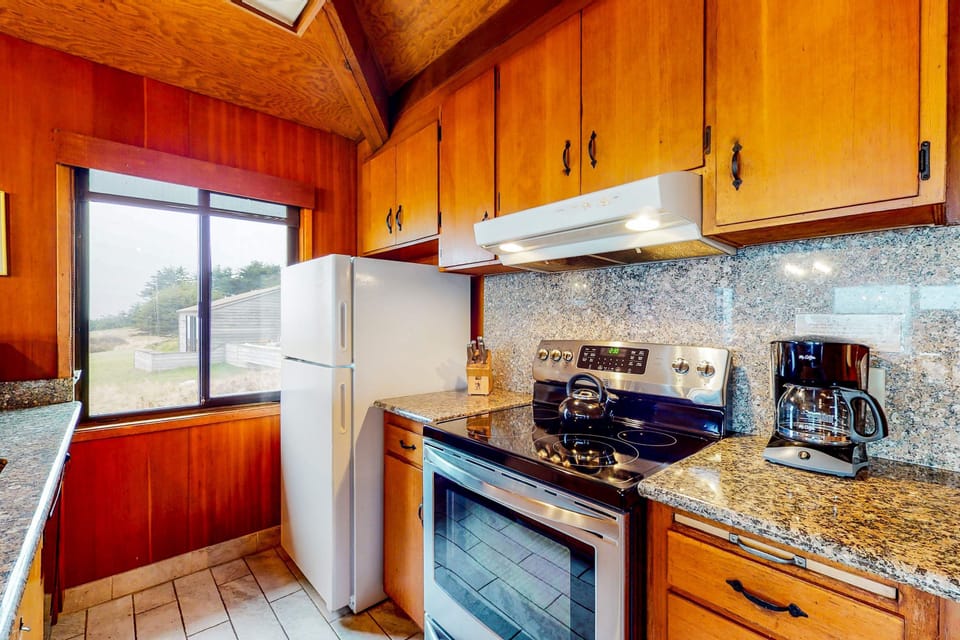 Channel your inner chef in this well-equipped kitchen, designed for easy meal prep while enjoying glimpses of the coastal landscape.