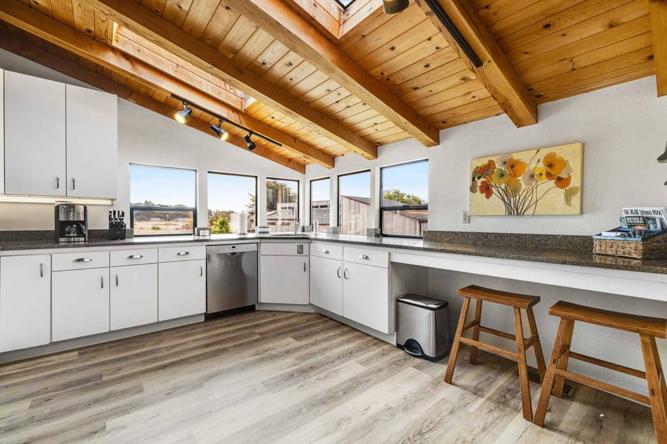 The spacious kitchen invites you to unleash your culinary creativity, with ample counter space and panoramic views.