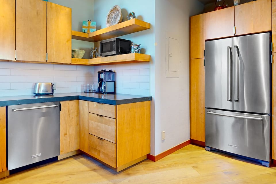 Enjoy the convenience of modern appliances and ample storage in this stylish kitchen, perfect for all your culinary needs.