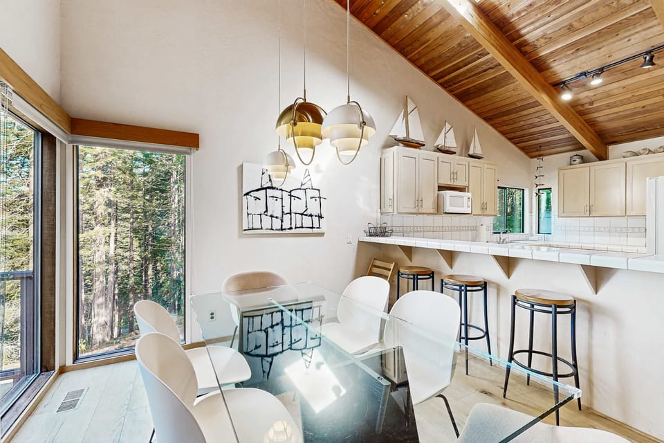 Experience effortless entertaining in this stylish dining space, perfect for enjoying meals while soaking in the forest ambiance.