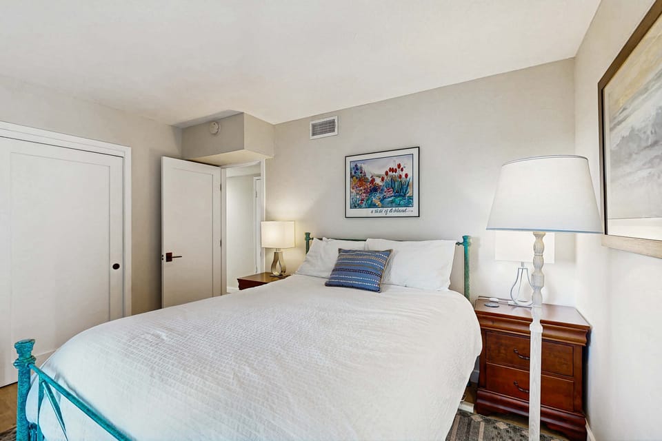 Bask in natural light in this charming master bedroom, where a cozy armchair invites you to savor a good book or morning coffee.