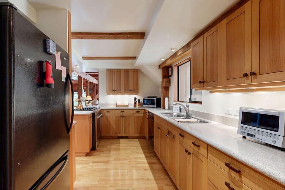 Craft culinary delights in this inviting kitchen, where ample counter space and modern appliances inspire your cooking adventures.