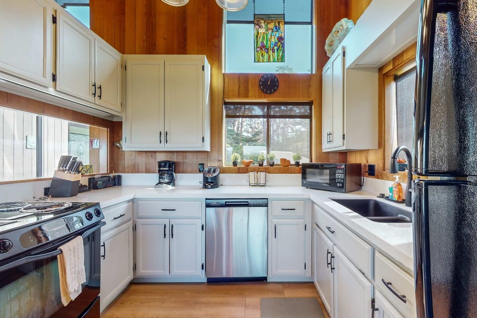 Cook culinary delights in this well-equipped kitchen, where natural light pours in, making meal prep a joyful experience.
