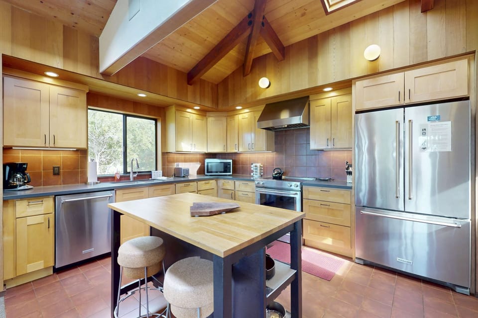 Cook up your favorite meals in this well-equipped kitchen, where modern amenities meet a warm, inviting atmosphere.