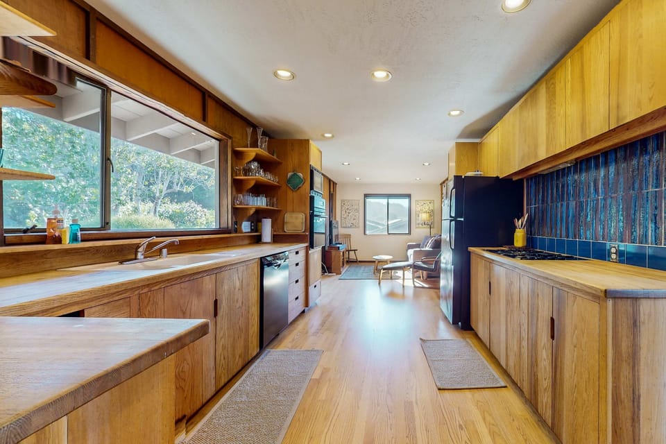 Cook up your favorite meals in the well-equipped kitchen, where modern amenities blend seamlessly with rustic charm and natural light.