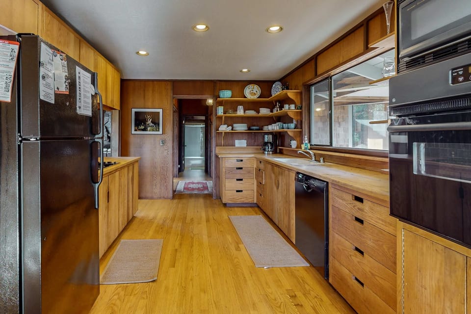 Prepare delicious meals in the inviting kitchen, where warm wood tones and modern amenities inspire culinary creativity and shared moments.