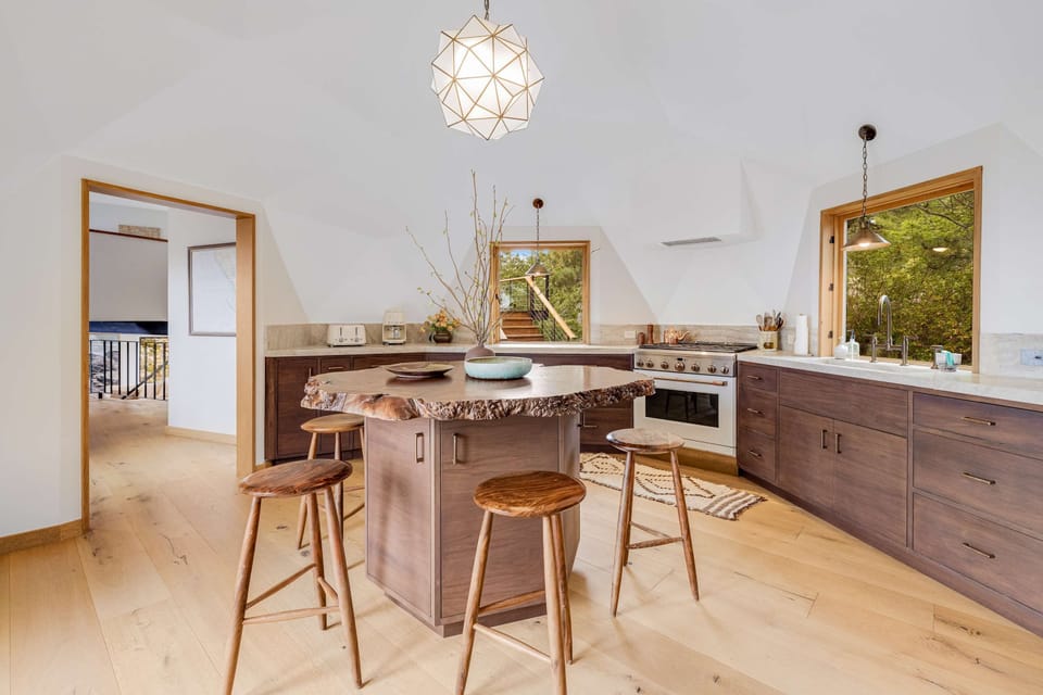 Gather around the unique island in this contemporary kitchen, an ideal spot for casual conversations while meals come to life.