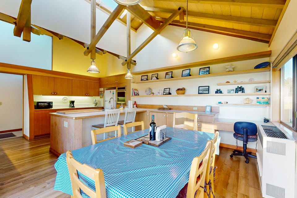 Gather around the spacious dining table, perfect for lively conversations and shared meals in a bright, airy atmosphere.