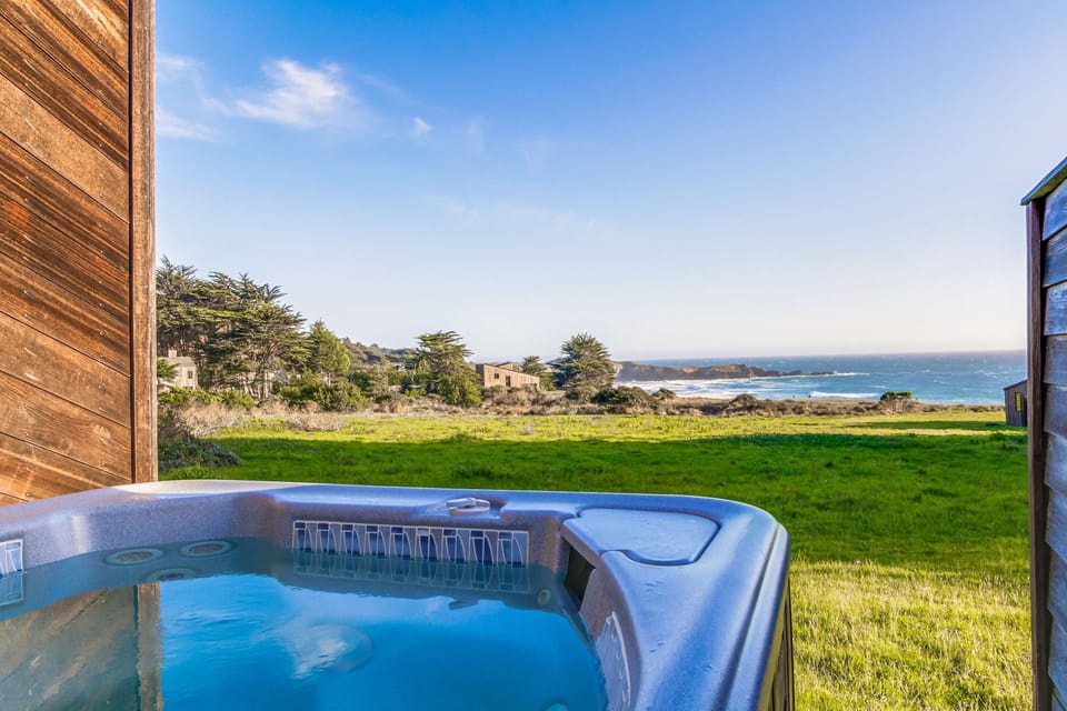 Soak under the stars in your private hot tub, where the ocean breeze and stunning views create the perfect evening ambiance.