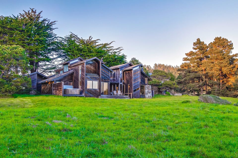 Admire the unique architecture of your coastal retreat, harmoniously blending with the lush surroundings for a truly immersive Sea Ranch experience.