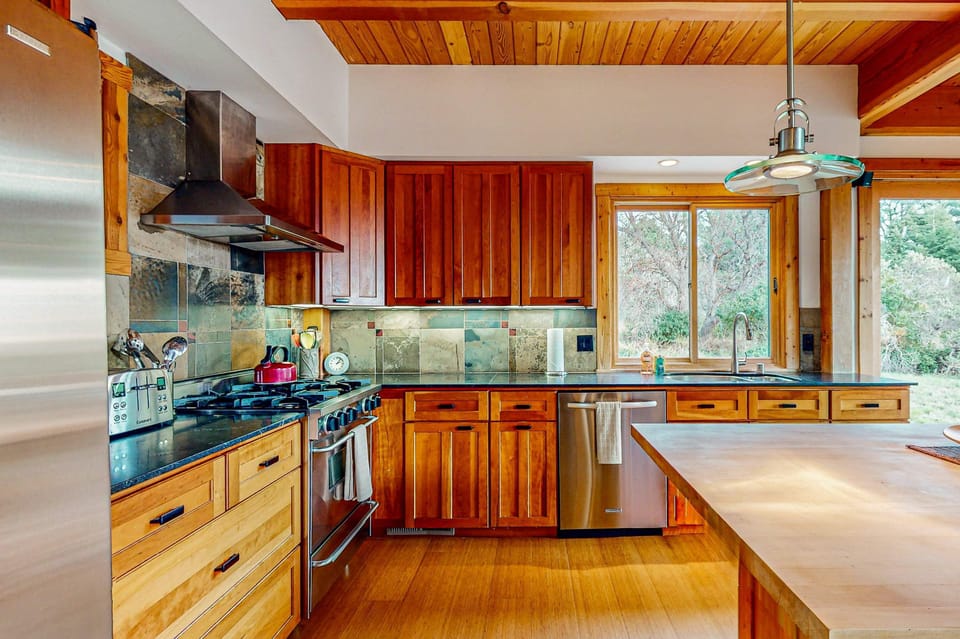 Your culinary creations come to life in this well-appointed kitchen, featuring modern appliances and ample counter space, perfect for preparing a feast.